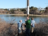 Volunteers lifting the pole into position