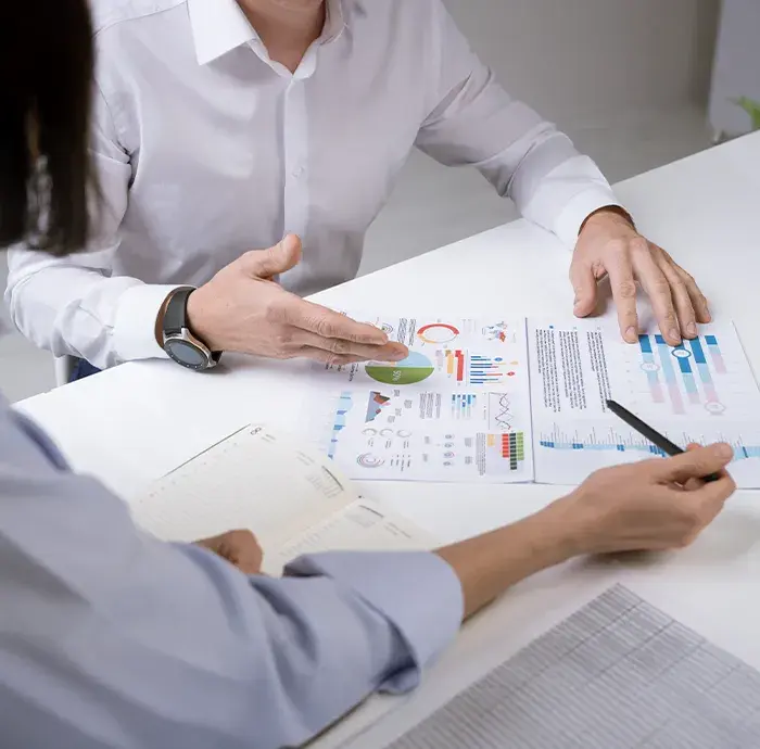 Products Two people discussing business charts and data