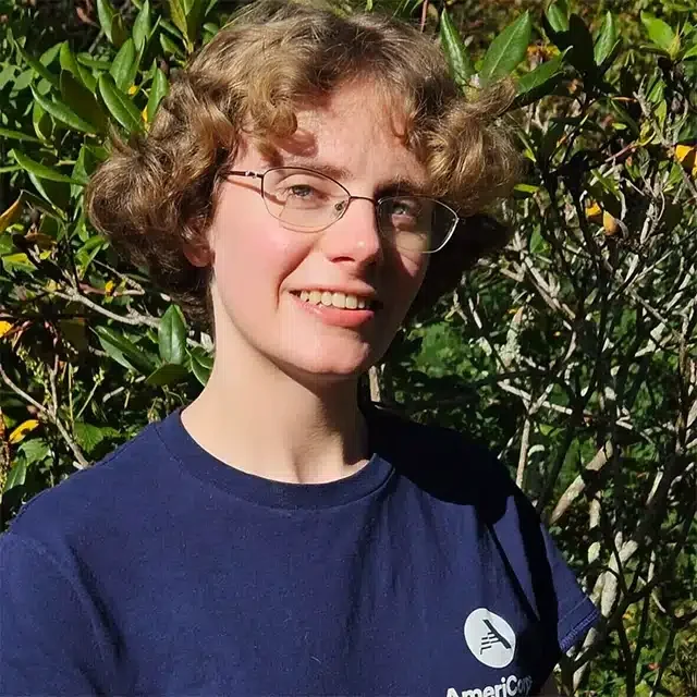 Smiling person wearing glasses outdoors