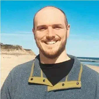 Smiling man standing on a beach