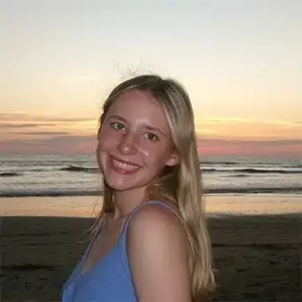 Smiling woman at the beach during sunset