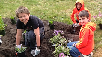 Kids doing plantation in a garden